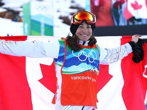 Maelle Ricker of Canada celebrates after her gold-medal performance in the ladies' snowboard cross at the Vancouver 2010 Winter Olympics on Feb. 16, 2010.