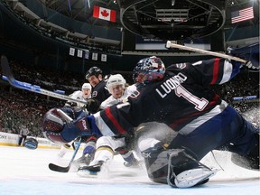 Antti Miettinen, centre, of the Dallas Stars beats goalie Roberto Luongo of the Canucks as Vancouver teammate Willie Mitchell, left, looks on during an NHL playoff game at GM Place on April 11, 2007. The Canucks scored in the fourth overtime to win 5-4.