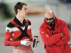 Canadian speed skater Dennis Morrison, left, talks with his coach Marcel Lacroix.