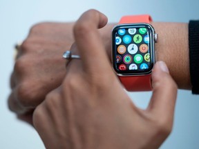 In this file photo taken on September 19, 2019 An employee demonstrate the new Apple watch inside the newly renovated Apple Store at Fifth Avenue on September 19, 2019 in New York City.