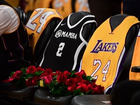Two seats are pictured covered with roses in honor of NBA legend Kobe Bryant and his daughter Gianna Bryant at the Staples Center, after they were killed last weekend in a helicopter accident, ahead of a game between Los Angeles Lakers and Portland Trail Blazers in Los Angeles, California on January 31, 2020.