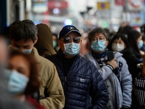 People queue to buy face masks from a shop in Hong Kong on February 1, 2020, as a preventative measure following a virus outbreak which began in the Chinese city of Wuhan.