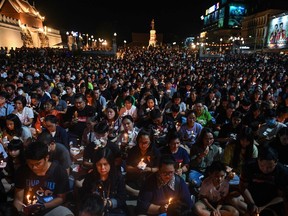 People gather for a candlelight vigil following a deadly mass shooting in Nakhon Ratchasima, Thailand, on Feb. 9, 2020.