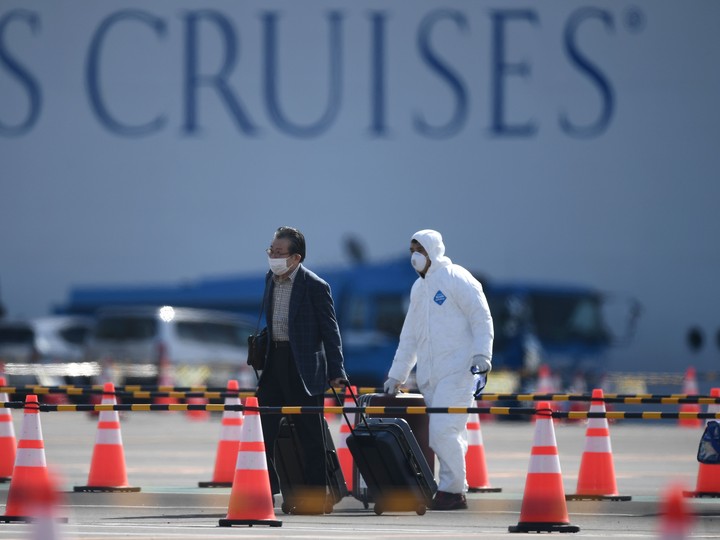  A passenger disembarks from the Diamond Princess cruise ship – in quarantine due to fears of the new COVID-19 coronavirus – at the Daikoku Pier Cruise Terminal in Yokohama on February 19, 2020.