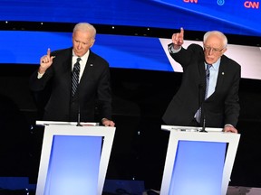 In this file photo taken on January 14, 2020 Democratic presidential hopefuls former Vice President Joe Biden (C) and Vermont Senator Bernie Sanders participate in the seventh Democratic primary debate of the 2020 presidential campaign season co-hosted by CNN and the Des Moines Register at the Drake University campus in Des Moines, Iowa.