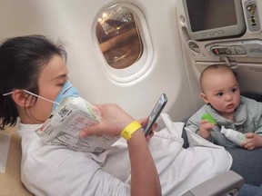 Summer Wu and her one-year-old son Felix wait on a plane destined for Canada to leave the Wuhan Tianhe International Airport early in the morning on Friday, Feb. 7, 2020.