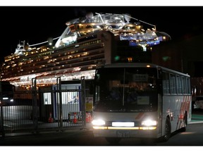 A bus transports passengers after they left the coronavirus-hit cruise ship Diamond Princess at the Daikoku Pier Cruise Terminal in Yokohama.