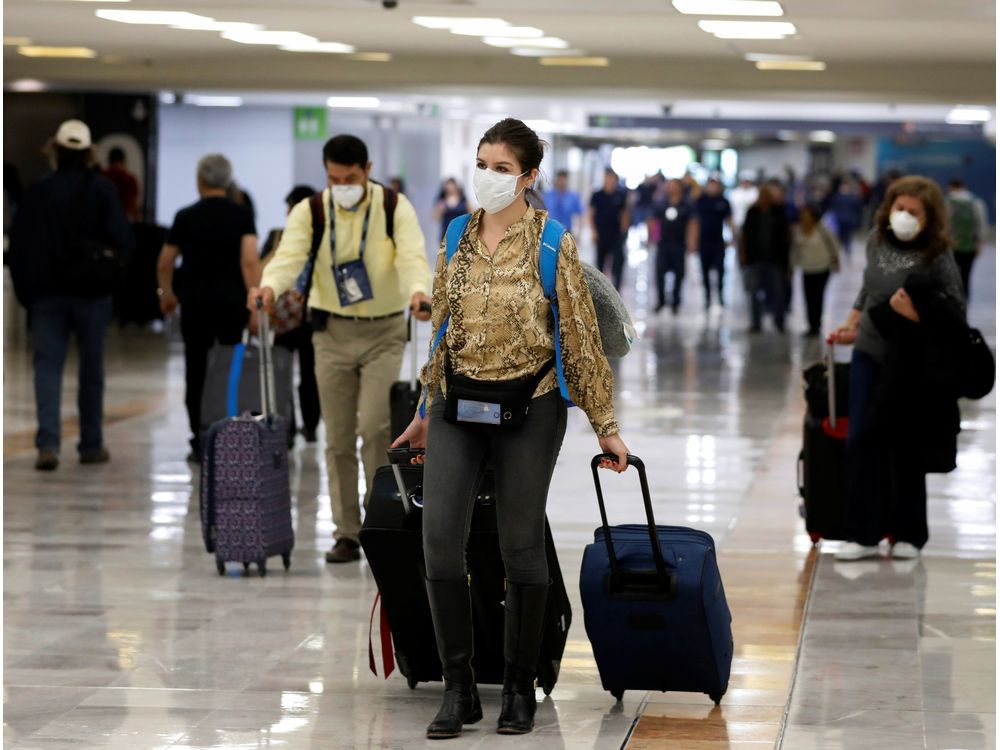  People wear protective face masks at Benito Juarez International Airport after Mexico’s government said on Friday it had detected the country’s first cases of coronavirus infection, in Mexico City on Feb. 28, 2020.