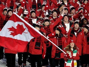 The host Canadian Olympic team led by Clara Hughes enters the stadium during the Opening Ceremony in Vancouver, BC on February 12, 2010 during the 2010 Winter Olympics. (John Mahoney / Canwest News Service)  CNS-OLY-FAVOURITE