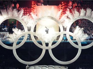 VANCOUVER, BC: FEBRUARY 12, 2010 -- A snowboarder flies through the Olympic Rings at BC Place Stadium during the  opening ceremony for the 2010 Winter Olympic Games in Vancouver February 12, 2010.  (Ric Ernst / Canwest News Service).  CNS-OLY-OPEN Snowboarder Launches the Opening This was shot at the beginning of the opening ceremony in BC Place Stadium and it seemed to really set the tone for the evening if not the entire Games. Vancouver snowboarder Johnny Lyall had practised the stunt for months in Whistler and every night at the stadium from Jan. 17 onward. From my shooting position, I knew I had an excellent angle for this moment and just crossed my fingers I'd time it right.  ORG XMIT: POS2014020614043906   Canada Day Quiz