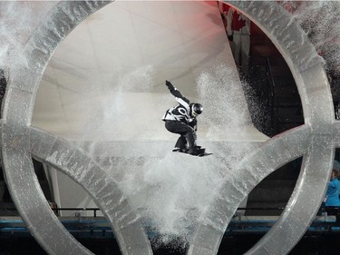 A snowboarder flies through the Olympic Rings during the Opening Ceremony in Vancouver, B.C. Friday, February 12, 2010 during the 2010 Winter Olympics. (John Mahoney/Canwest News Service)  CNS-OLY-OPEN [PNG Merlin Archive]