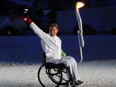 Rick Hansen carries the torch into the opening ceremony of the 2010 Winter Olympic Games held at B.C. Place in Vancouver February 12, 2010. (Photo by Larry Wong/Canwest News Service) CNS-OLY-OPEN [PNG Merlin Archive]