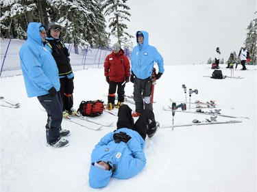 RESTRICTIONS ON USAGE - NO SALES TO OTHER PUBLICATIONS
WHISTLER,  B.C.:  February 12, 2010 Exausted race course workers fall down to rest after starting work in before dawn, only to have cancelation of the women's downhill   here Whistler, B.C. on Feb 12, 2010. The  downhill course's have been covered by fog for several days  at the winter games .  Mark van Manen/PNG)  see Gary Kingson Sun Sports  Vancouver Sun. /Province Sports games stories  CNS-OLY-SKI.jpg [PNG Merlin Archive]