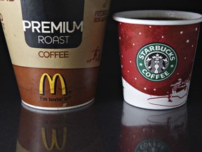 A McDonald's coffee cup is arranged for an illustration alongside a miniature Starbucks coffee cup in New York, on Tuesday, Jan. 8, 2007.