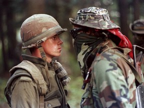 Canadian soldier Patrick Cloutier and Saskatchewan native Brad Laroque come face-to-face in a tense standoff at the Kahnesatake reserve in Oka, Que., Saturday September 1, 1990. The ghosts of Indigenous protests past have hovered over Prime Minister Justin Trudeau as his government struggles to bring a peaceful end to blockades that have disrupted traffic on rail lines and other major transportation routes across the country for more than two weeks.