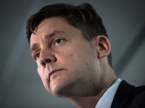 British Columbia Attorney General David Eby listens during a news conference in Vancouver, on Friday May 24, 2019. British Columbia's attorney general hopes an inquiry into money laundering will answer lingering questions about how the criminal activity flourished in the province and identify specific people who allowed it to happen.