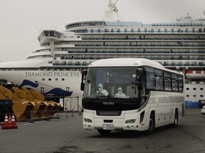 A bus leaves a port where the quarantined Diamond Princess cruise ship is docked Saturday, Feb. 15, 2020, in Yokohama, near Tokyo. THE CANADIAN PRESS/AP-Jae C. Hong