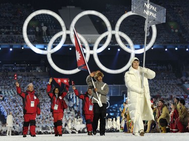 The Nepalese delegation tours the stadium, with Nepal's cross-country skier Dachhiri  Sherpa as the flag bearer, at BC Place during the opening ceremony of the 2010 Winter Olympics in Vancouver on February 12, 2010.  AFP PHOTO / DDP / MICHAEL KAPPELER (Photo credit should read MICHAEL KAPPELER/AFP/Getty Images) ORG XMIT: 95658513