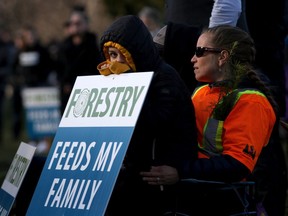 Kylie Drover, 11, and her step-mother Kim Brown look on as they take part in a forest industry rally on the front lawn the same day as Minister of Finance Carole James delivered the budget speech at B.C. Legislature in Victoria, Tuesday, Feb. 18, 2020.