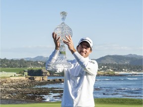 February 9, 2020; Pebble Beach, California, USA; Nick Taylor hoists the trophy during the final round of the AT&T Pebble Beach Pro-Am golf tournament at Pebble Beach Golf Links. Mandatory Credit: Kyle Terada-USA TODAY Sports
