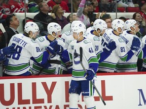 Canucks centre Elias Pettersson gets congratulated by teammates after his first-period goal, the first of his two goals on the day, against the Carolina Hurricanes during their NHL game Sunday at PNC Arena in Raleigh, N.C.