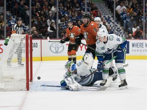 Anaheim Ducks forward Nick Ritchie (37) and Vancouver Canucks defenceman Troy Stecher (51) look on as Anaheim Ducks forward Adam Henrique (14) scores on Vancouver Canucks goalie Thatcher Demko (35) at Rogers Arena recently.