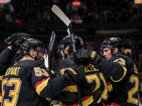 Vancouver Canucks forward Bo Horvat (53) and forward Zack MacEwen (71) and defenceman Alexander Edler (23) celebrate MacEwan's first period goal against the Nashville Predators.