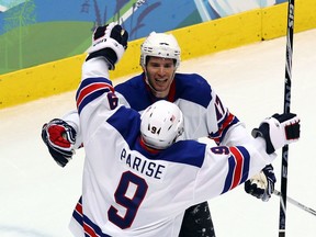 Zach Parise of Team USA and teammate Ryan Kesler celebrate after Kesler scored an empty net goal during the men's hockey preliminary game between Canada and the U.S. on Day 10 of the Vancouver 2010 Winter Olympics at Canada Hockey Place on Feb. 21, 2010 in Vancouver. Team USA won 5-3.