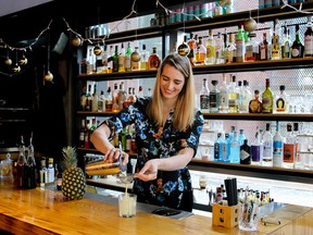 Sabrine Dhaliwal, bar manager of Juke Fried Chicken, serves her Looking Pine low-proof cocktail.