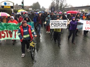 Protesters march along Grandview Highway on Saturday in Vancouver.