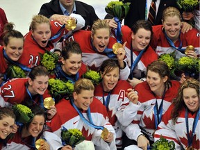 Canadian players celebrate with their gold medals after shutting out the United States 2-0 in the final of the women's ice hockey tournament at the Vancouver Winter Olympics on Feb. 25, 2010.