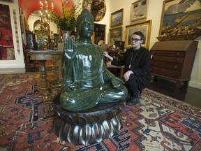 Irina Rakina looks over a jade Buddha at Uno Langman antiques in Vancouver.