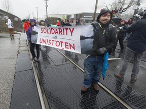 People march in support of the Wet'suwet'en hereditary chiefs in their opposition to the Coastal GasLink pipeline project, along Grandview Highway in Vancouver.