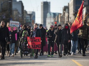 Approximately 100 people block East Hastings street on Tuesday afternoon.