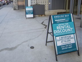 Signs for new rental units on Davie Street offer discounts for a one-year lease.