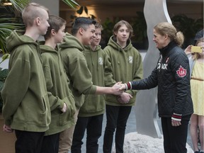 Canada's Governor General Julie Payette honours to five teens, including (from left) Samuel North, Joshua Ravensbergen, James MacDonald, Gabriel Neilson and Ethan Harvey, who saved a young boy who was dangling from a chairlift at Grouse Mountain last year during a ceremony at North Vancouver District Hall on Saturday, February 22, 2020.