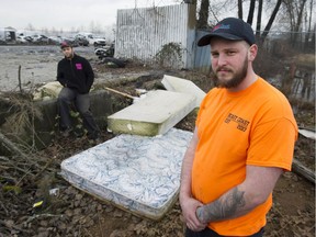 Rob Rice (in orange) and Gregory Snurnitsyn joined forces in 2020 to fight trash in Surrey, B.C. The pair are pictured near discarded mattresses at an illegal dumping spot along Scott Road Wednesday, February 26, 2020, that should soon be a thing of the past due to new mattress recycling regulations.