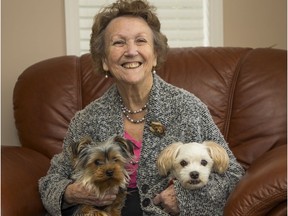 Gail Cross with dogs Buddy and Scooter. Cross' family is questioning a Fraser Health protocol that requires her to lock up the dogs when home health support workers visit.