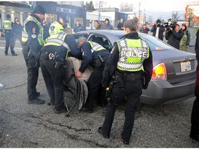 VANCOUVER, B.C.; February 10, 2020 — An elderly woman is arrested after police were compelled to act on a BC Supreme Court order, in response to a request from the Vancouver Fraser Port Authority, to restore access to the Vancouver ports in Vancouver, B.C. on February 10, 2020. A number of protesters refused to abide by the court order. So far, 33 arrests have been made. Protesters received several requests from police to clear the intersection and then warnings prior to being detained.