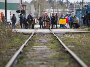 Protesters block a rail line at Venables at Glen drive in Vancouver.