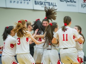 Terry Fox Ravens celebrate their gritty 76-73 win over Lord Tweedsmuir in Quad A girls high school basketball action at Langley Events Centre on Thursday.