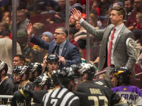 Vancouver Warriors coach Chris Gill, centre, and assistant coach Clayton Richardson, right, guided the team to a second-straight low scoring win Saturday.