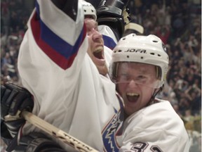 Trent Klatt and Herik Sedin celebrate the first Vancouver Canucks' goal during NHL playoff action at GM Place on April 16, 2001.