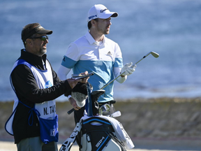 Nick Taylor (right) and his caddie on the 18th hole during the second round of the AT&T Pebble Beach Pro-Am golf tournament at Pebble Beach Golf Links.