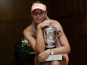 Maria Sharapova poses with the Coupe Suzanne Lenglen in her changing room following her victory at the French Open at Roland Garros on June 7, 2014 in Paris. (Sindy Thomas - Pool/Getty Images)