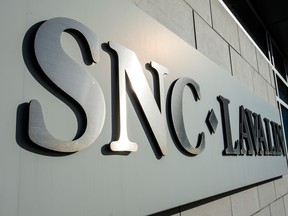 SNC-Lavalin reported a fourth-quarter loss Friday due to a fraud fine and restructuring costs, but swung into profit for the year on revenue that beat expectations.