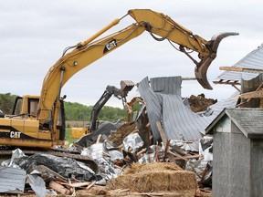 A demolition crew tears down Frank Meyers' barn in Quinte West, Ont., on Wednesday, May 28, 2014. The Liberal government is pulling the plug on a 12-year-old plan to move the military's elite Joint Task Force 2 from its base near the national capital. Among those whose land expropriated was local farmer Frank Meyers, whose ultimately unsuccessful fight to keep his 90-hectare farm north of CFB Trenton made national headlines.