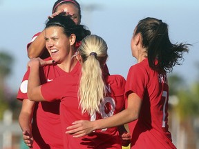 Canada's Christine Sinclair, front left, celebrates with teammates after scoring against St. Kitts and Nevis during a CONCACAF women's Olympic qualifying soccer match Wednesday, Jan. 29, 2020, in Edinburg, Texas. (Joel Martinez/The Monitor via AP) ORG XMIT: TXMCA102
