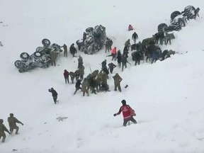 Turkish soldiers and locals try to rescue people trapped under avalanche in Bahcesaray in Van province, Turkey, February 5, 2020, in this still image taken from video.