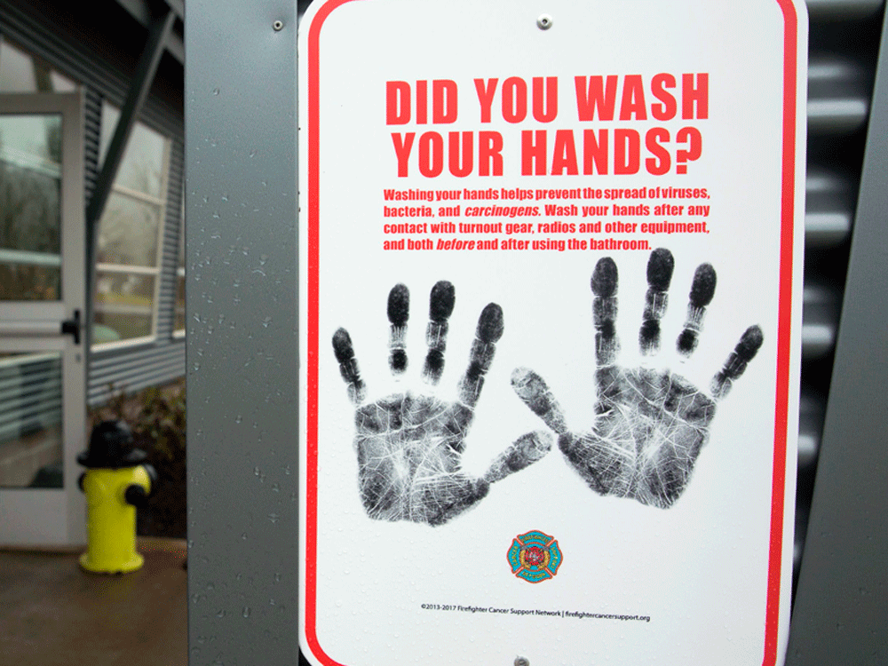  A sign reminding people to wash their hands outside a dormitory designated as a 2019 novel coronavirus quarantine site in North Bend, Washington.